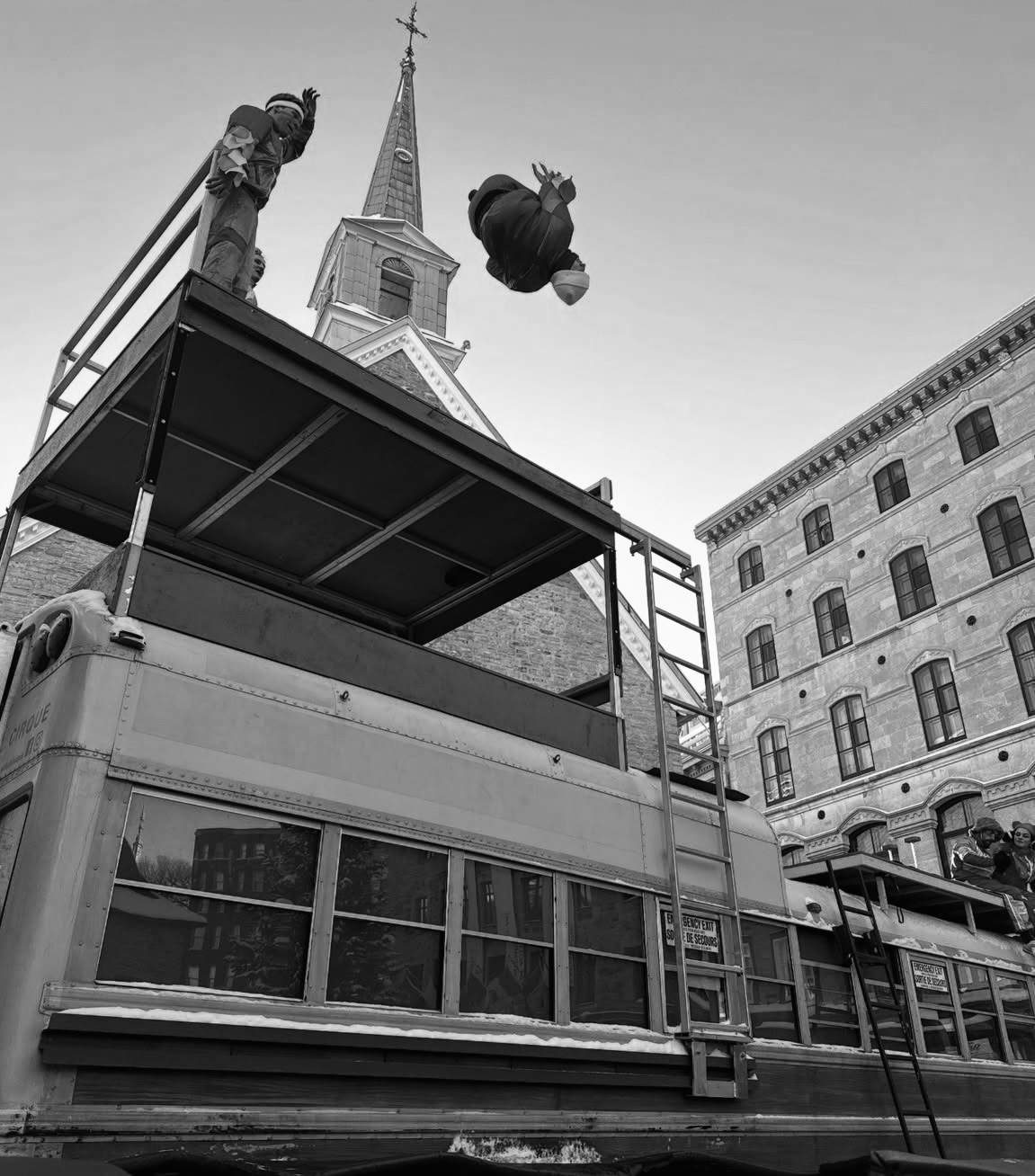 Acrobatic performance above a circus bus