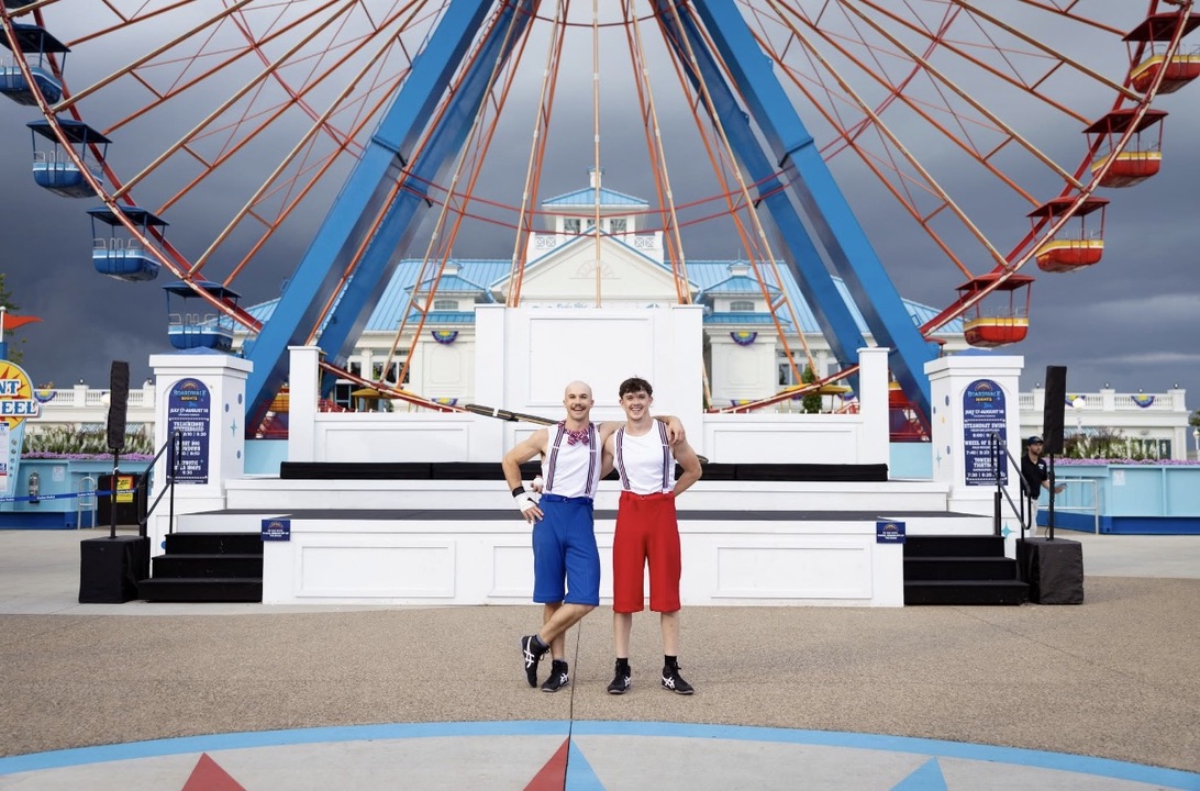 Avery and a partner in front of the Boardwalk Nights stage