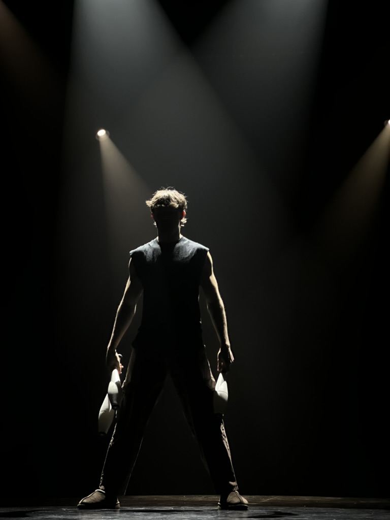 Avery on stage under spotlights